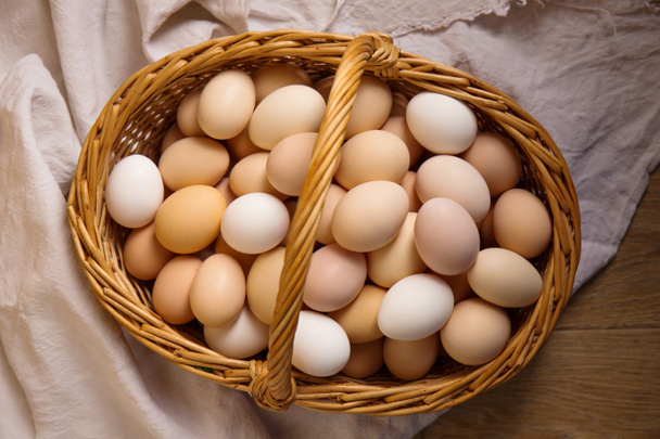 Large basket of chicken eggs photo in rustic style - Photo, Image