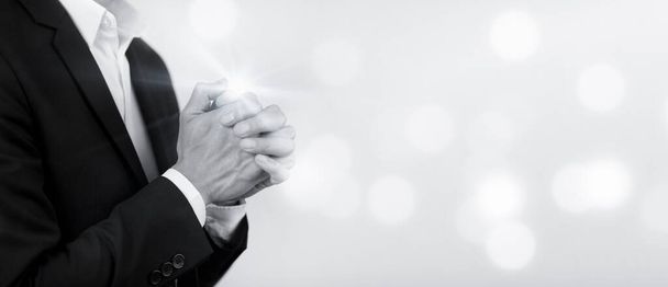 Businessman hand praying and worship to GOD Using hands to pray on the white Background, worship, hands in prayer concept for faith, spirituality and religion, hands raised in worship background. - Photo, Image