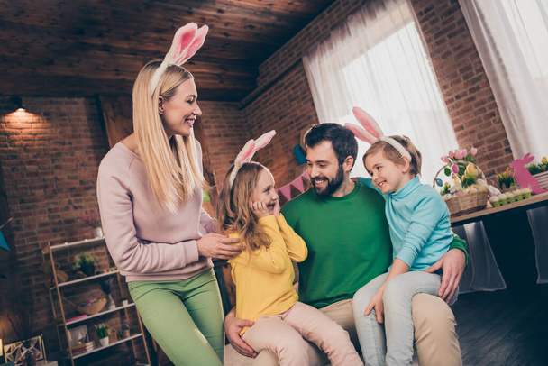 Portrait of four peaceful funny people kids sit dad legs hug embrace spend weekend together house indoors - Фото, зображення