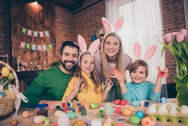Photo of full beautiful family prepare easter eggs hands paint have fun festive atmosphere house indoors - 写真・画像