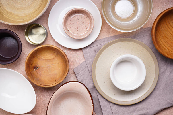 Ceramic tableware on beige background, top view. Close-up. - Foto, afbeelding