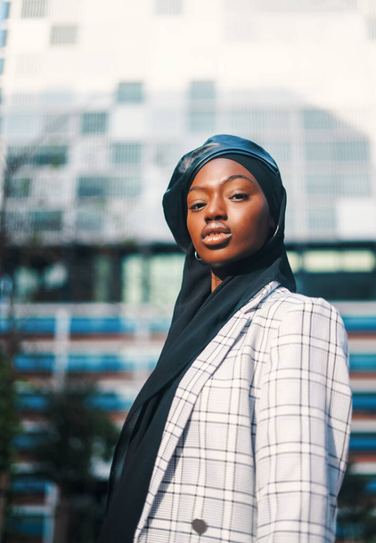 Confident black woman in traditional headscarf and formal wear - Photo, Image