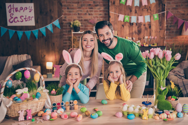 Photo of happy positive family spend time together indoors celebrate easter holiday paint eggs make crafts decorations - Photo, Image