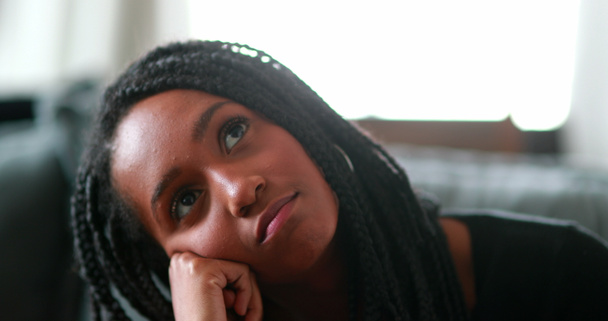Pensive black teen girl thinking, Thoughtful African mixed race young woman - 写真・画像