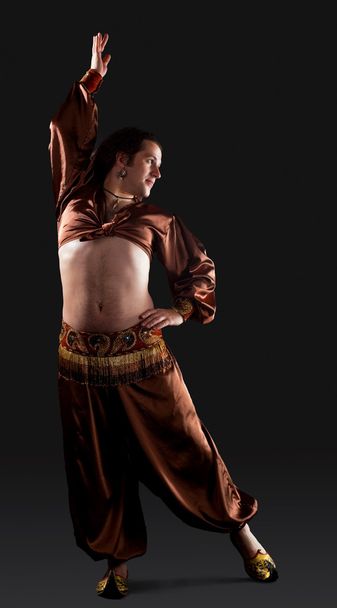 Man dance in brown traditional arabian costume - Valokuva, kuva