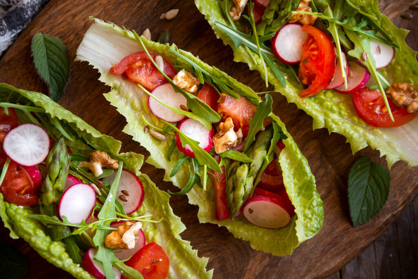 Vegetable salad served in lettuce leaves, healthy food or snack - 写真・画像