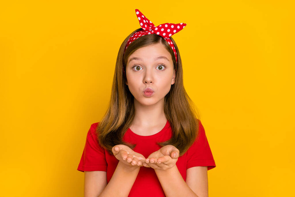 Portrait of adorable kind teenager little girl send you appreciation kiss wear isolated on yellow color background - Фото, зображення