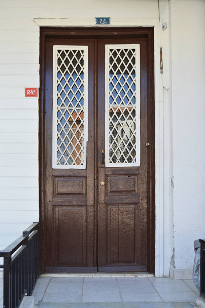 Old brown color wooden entrance door of house in Turkey Istanbul Buyukada - Photo, Image
