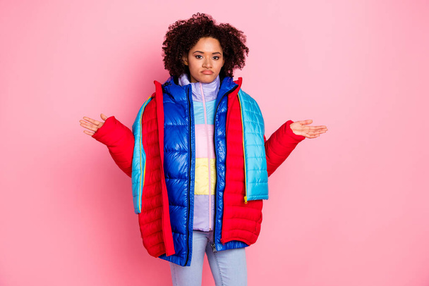 Photo of young pretty girl wear many jackets shrug shoulders puzzled unsure dislike outfit isolated over pink color background - Foto, Imagen