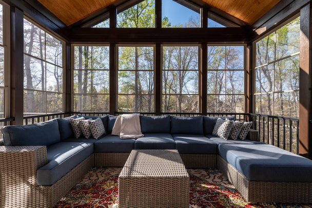 Cozy screened porch in springtime, full of blooms trees in the background. - Photo, Image
