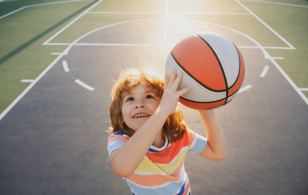 Child boy preparing for basketball shooting. Portrait of sporty kids. - Foto, immagini