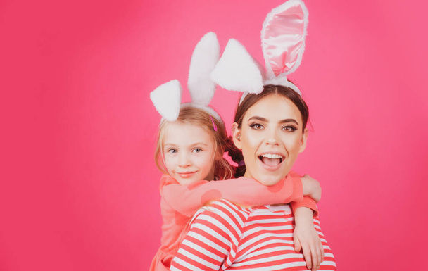 Girl friends happy easter. Happy childhood concept. Small sister female bunny ears isolated on pink background. - Valokuva, kuva