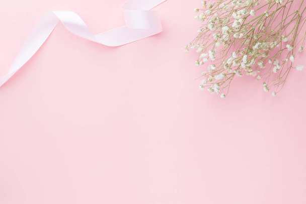 Gypsophila flowers on pink pastel background, Minimalism, Spring flower blosssom concept, Flat lay, top view, copy space - Foto, Imagem