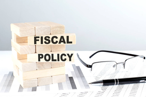 FISCAL POLICY is written on a wooden blocks on a chart background - Photo, Image