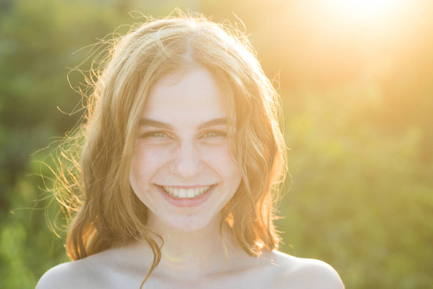 Natural female beauty. Young teen woman with clean fresh skin. Close up portrait of smiling teenager, closeup face of beautiful girl outdoor. Soft sunny sunlight on sunny summer day. - Foto, Imagem