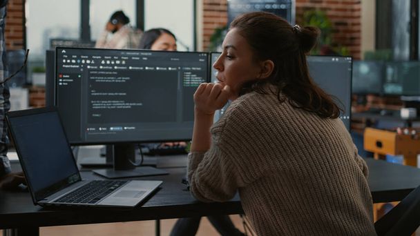 Junior developer putting laptop with source code on senior dev desk asking for opinion - Fotó, kép