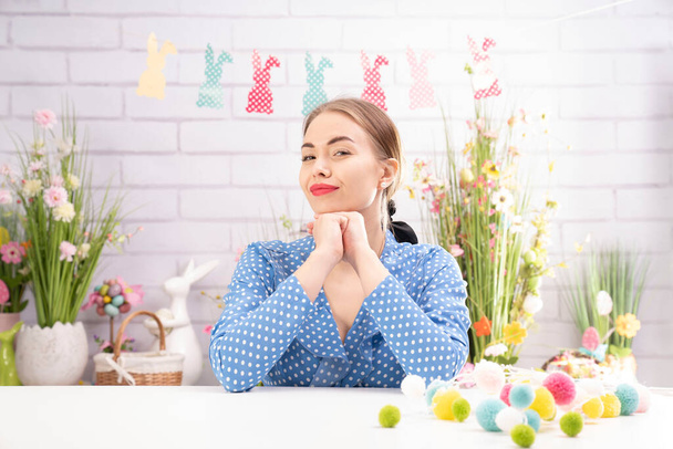 Pretty young women  preparing easter decorations.  Easter background. Bouquets of spring flowers. Easter eggs in baskets. - Fotoğraf, Görsel