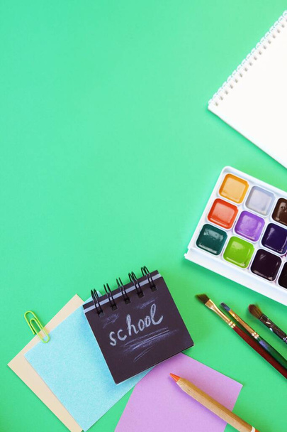 Art materials and stationery on a green background, top view, back to school, holidays, education and training - Photo, Image