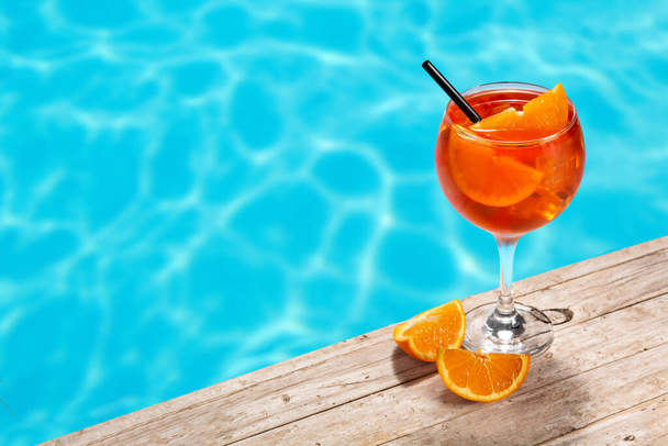 Glass of aperol spritz cocktail and swimming pool.Copy space - Fotoğraf, Görsel