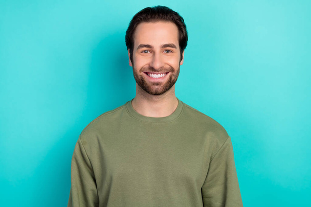 Photo of funky brunet millennial man wear green shirt isolated on teal color background - Foto, afbeelding