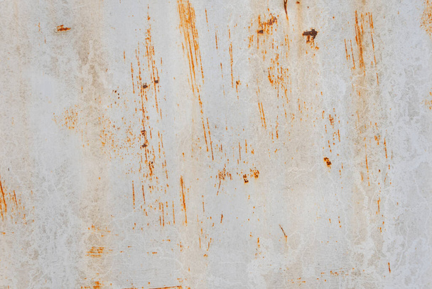 The texture of brown rust and stains on the old metal surface, selective focus. Metal corrosion, peeling paint. - Photo, Image