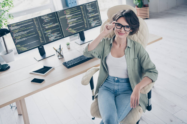 High angle view photo of confident successful web designer sitting chair hand touch spectacles office indoors - Foto, immagini