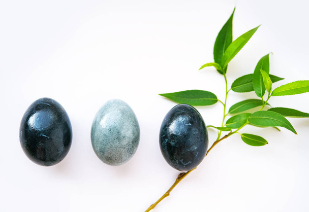 Dark blue Easter eggs on gray background - Фото, изображение
