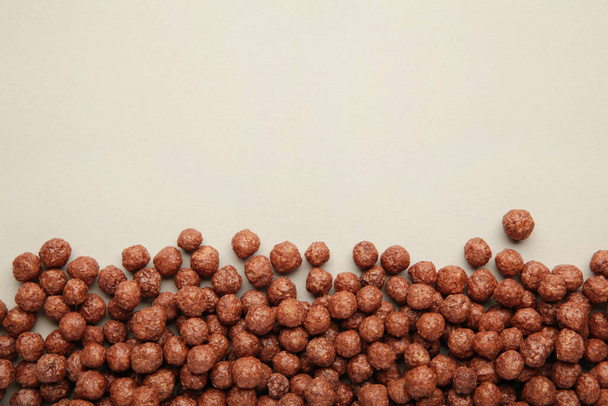 Chocolate cereal corn balls on a grey background. Top view. - Fotó, kép