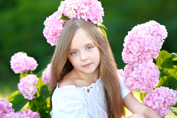 portrait of little girl with flowers hydrangea - 写真・画像