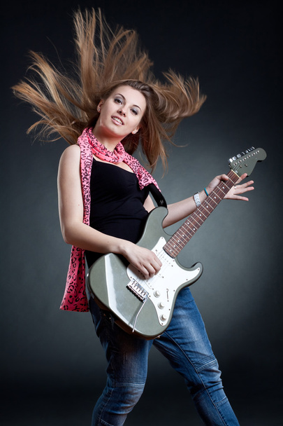 Headbanging woman guitarist playing her guitar - Photo, Image