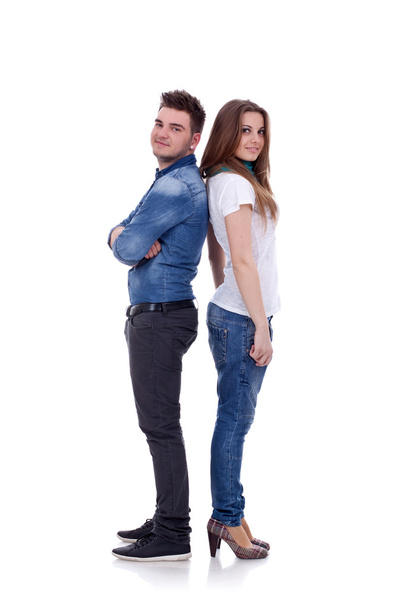 Smiling young couple standing back to back - Foto, Bild