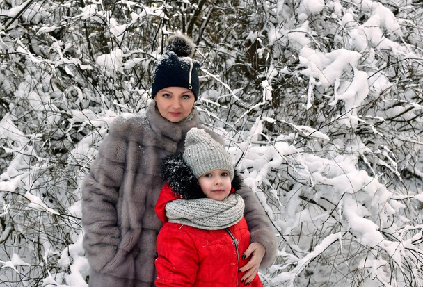 Walk mother and daughter girls in a beautiful, fabulous snowy forest. - Photo, Image