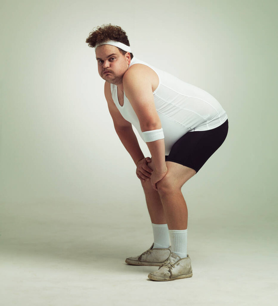 Seriously...The workout was like 6min straight.... Shot of an overweight man crouching after a workout. - Foto, imagen