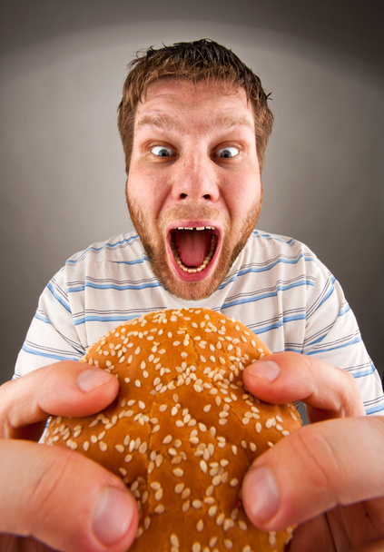 Man eating juicy hamburger - Valokuva, kuva