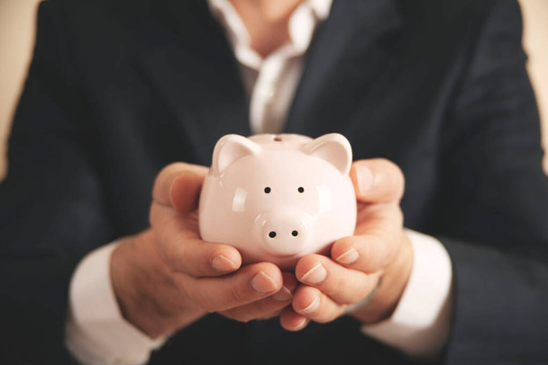 Man putting coin in piggy bank. saving money, finance concept - Фото, зображення