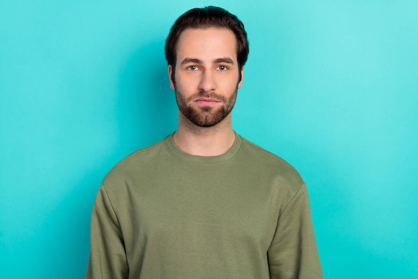 Photo of nice brunet man wear green shirt isolated on teal color background - 写真・画像