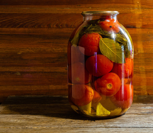 Pickled tomatoes in a three-liter jar. Homemade products and pickles. - Фото, изображение