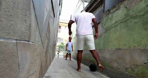 African father and son playing soccer at home, Dad and child bonding - Photo, image
