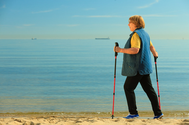Woman senior walking on beach - Фото, зображення