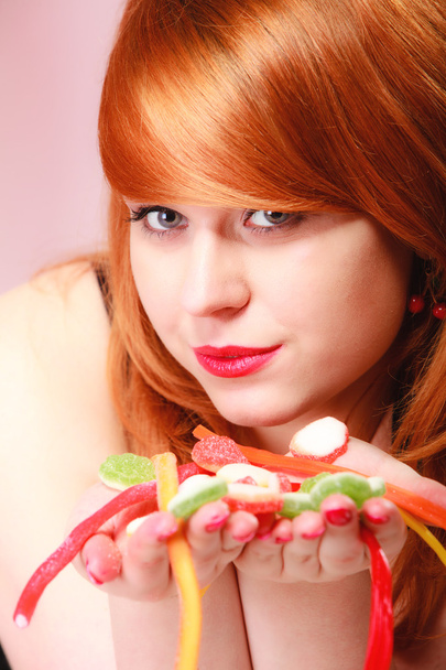 Redhair girl holding jelly candy - Foto, immagini