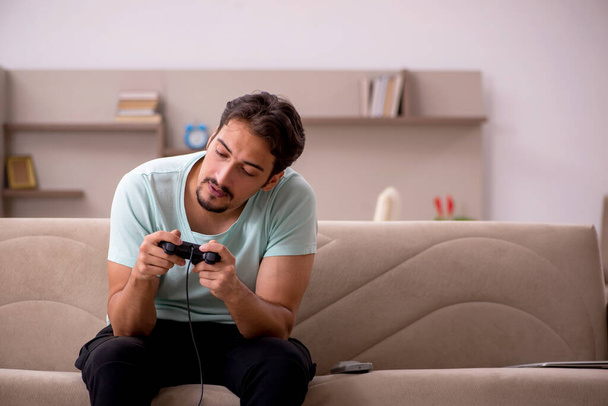 Young man playing joystick games at home - Photo, Image