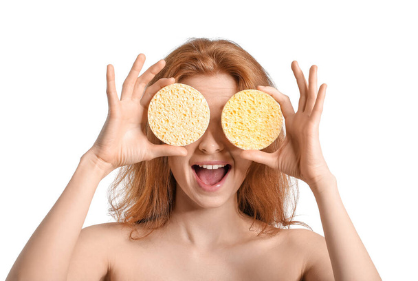 Happy woman with makeup sponges on white background - Fotó, kép
