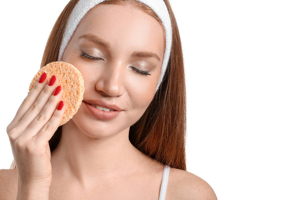 Beautiful woman with makeup sponge on white background - Photo, Image