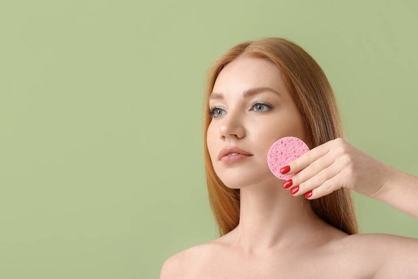 Beautiful woman with makeup sponge on color background - Photo, Image