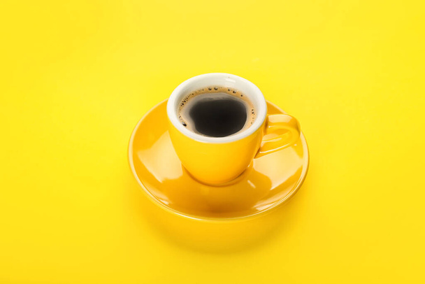 Cup of hot coffee on yellow background - Photo, image