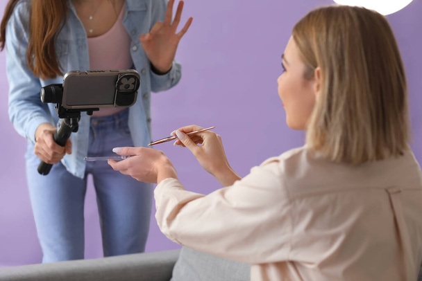 Young female beauty bloggers recording video in studio - Photo, Image