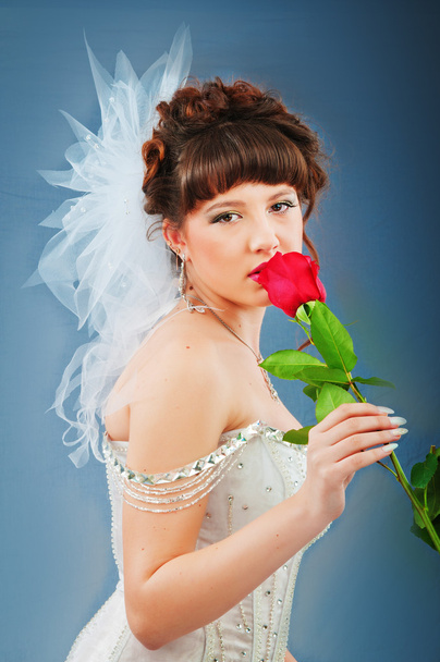 Beautiful bride with rose in studio shooting - Foto, Imagen