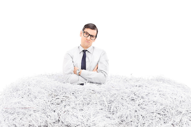 Man in pile of shredded paper - 写真・画像