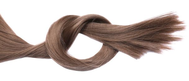 Beautiful strand of dark blonde hair tied in knot on white background, top view - 写真・画像