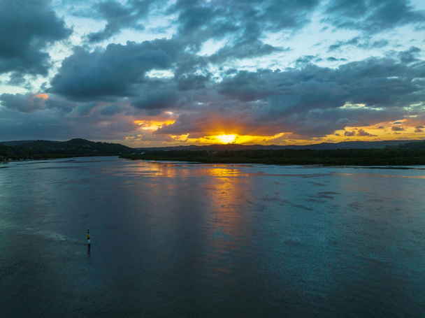 Aerial sunrise over the bay with rain clouds at Woy Woy on the Central Coast, NSW, Australia. - Fotó, kép